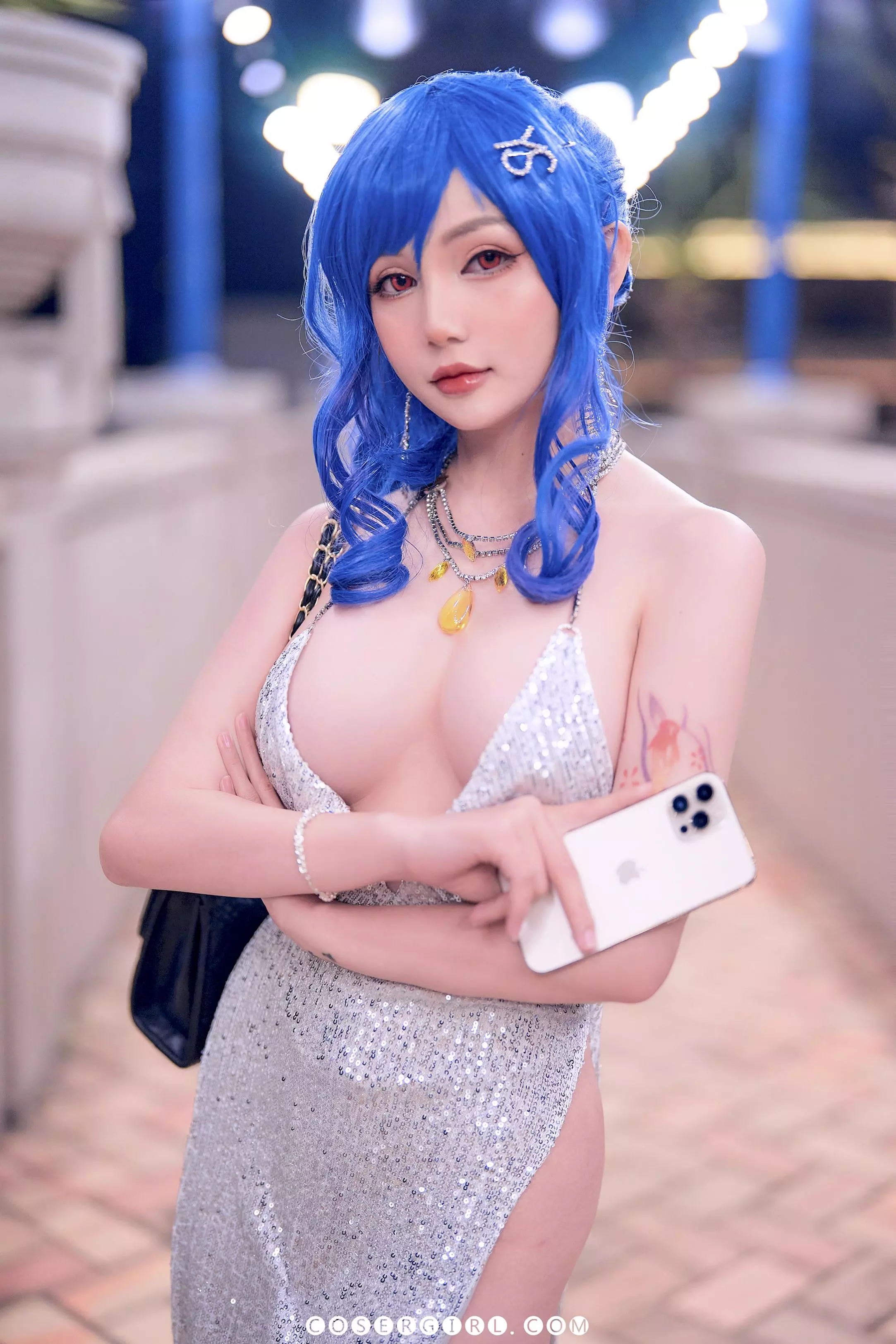Coser Joyce扮演圣路易斯,身穿银色亮片裙,在夜色沙滩上闭眼坐着,一手拿着啤酒罐。